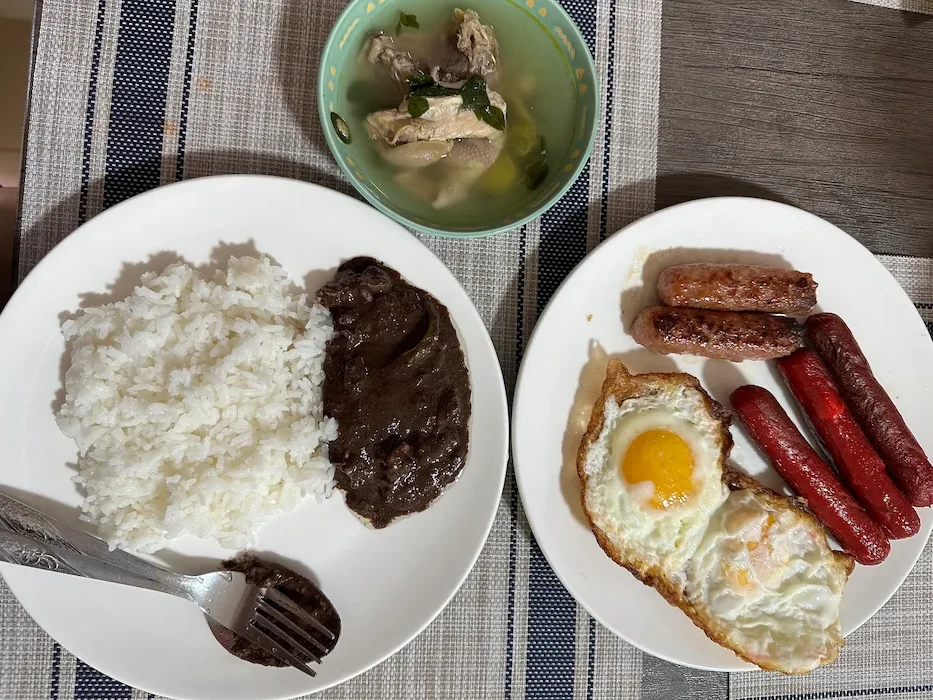 A typical Filipino meal: Fried hotdogs and eggs, tinolang manok (chicken soup) and dinuguan
