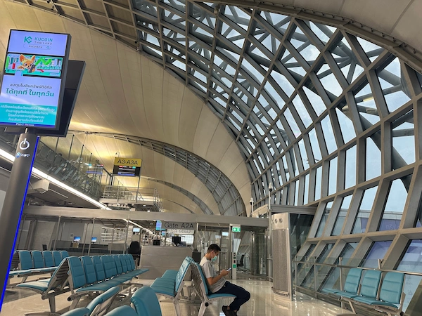 Few people waiting and using their phone in the airport