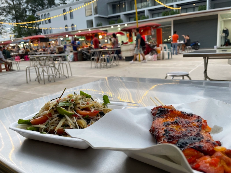 Thai food papaya somtam and grilled chicken in a night market
