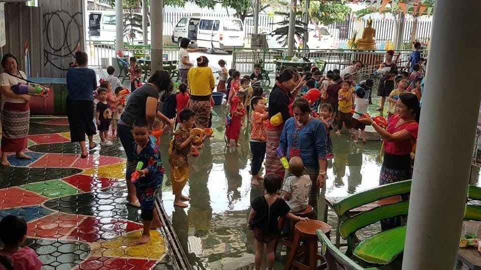 Thais and children playing with water during Songkran