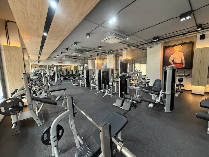 Picture taken inside of the ABSolute Gym in Chiang Mai, Thailand, showing the gym equipment in the first floor of the building and the dumbbell area.