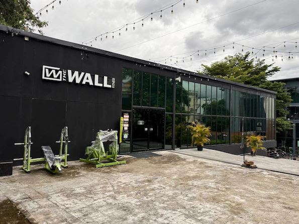 Picture take in front of the Wall fitness center in Chiang Mai Thailand. The picture shows the entrance area of the gym and the building.