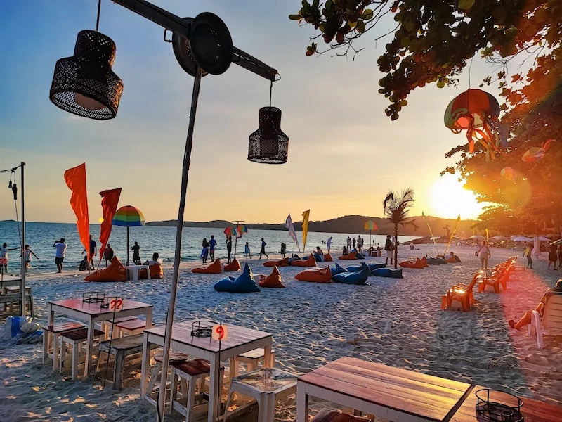 A fresh seafood and meat barbecue being cooked on a grill on the beach at night in Koh Samet.