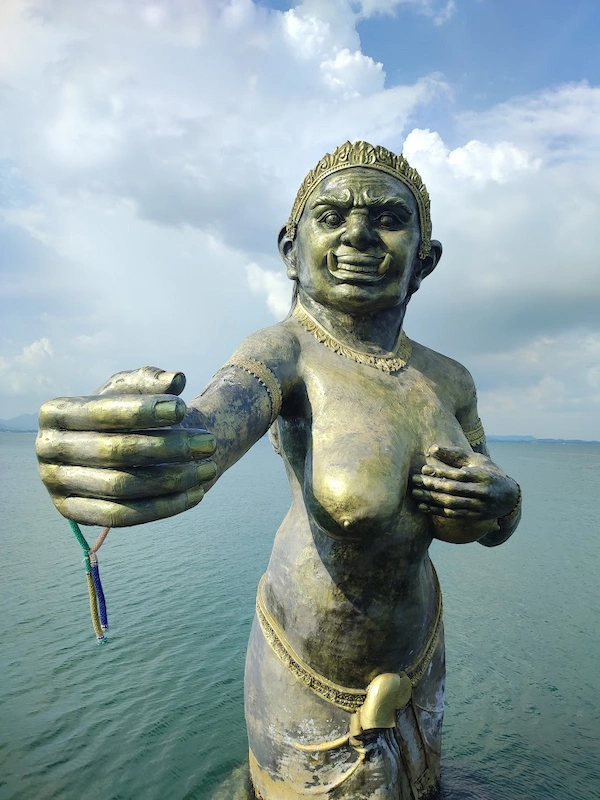 Close-up of the golden mermaid statue at the entrance to Na Dan Pier on Koh Samet.