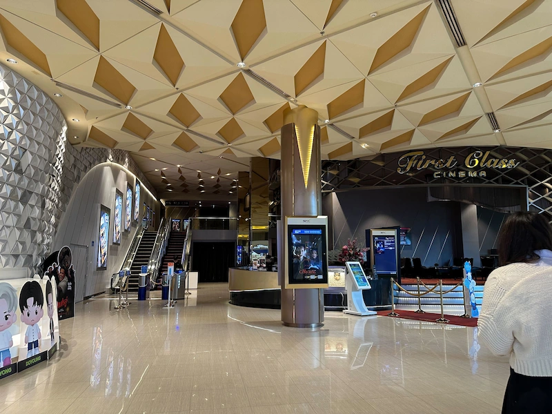 Photo of the cinema area of MAYA mall, schedule of the movies shown and the escalator leading to the theatres