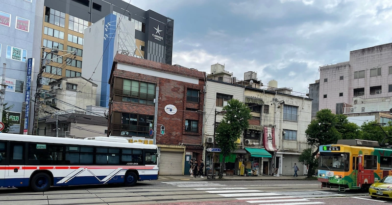 Photo of a road view, a bus and a tram in sight on a cloudy afternoon