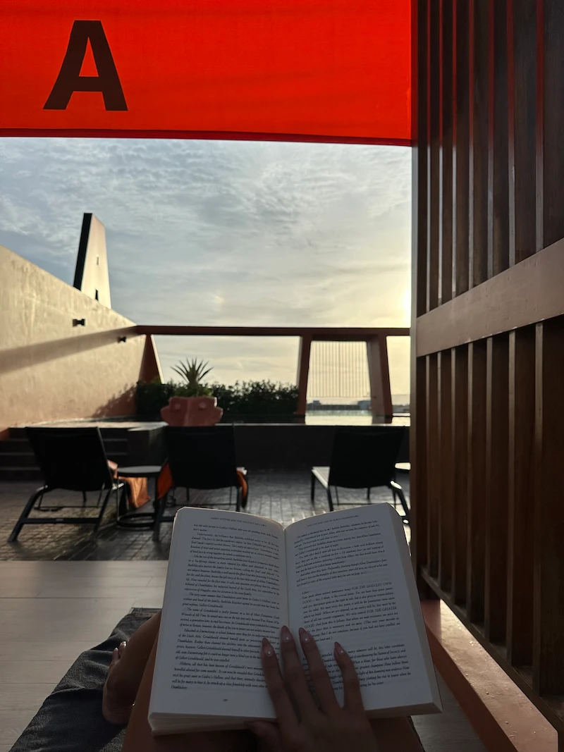 Relaxing with a book by a private pool in Krabi during the quiet shoulder season sunset