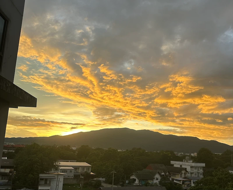 Golden sunset clouds over Doi Suthep mountain in Chiang Mai viewing the city without smog in November