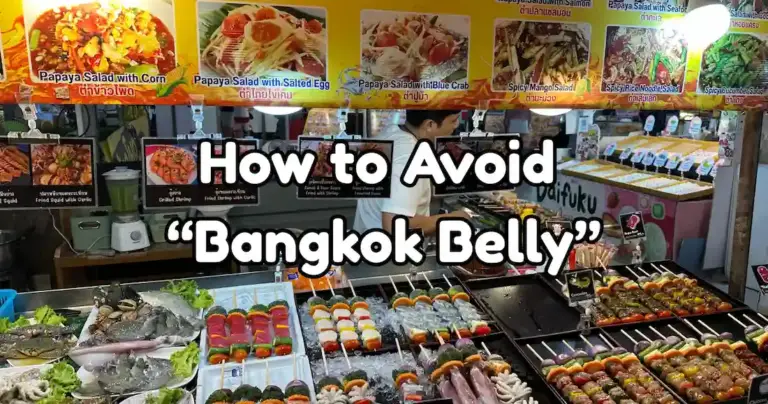 A vibrant display of fresh raw seafood and meat skewers on ice at a market stall with the superimposed title text "How to Avoid 'Bangkok Belly'."