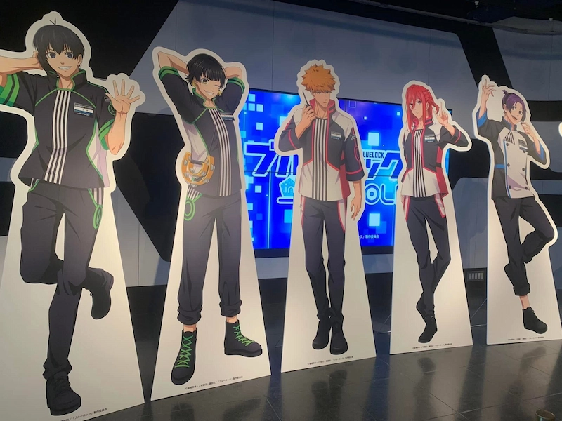 Life-sized anime character cutouts from Blue Lock at a Tokyo Joypolis collaboration event.