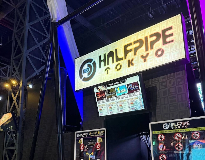 Bright neon signage for the Halfpipe Tokyo rhythm and spinning ride at Joypolis.