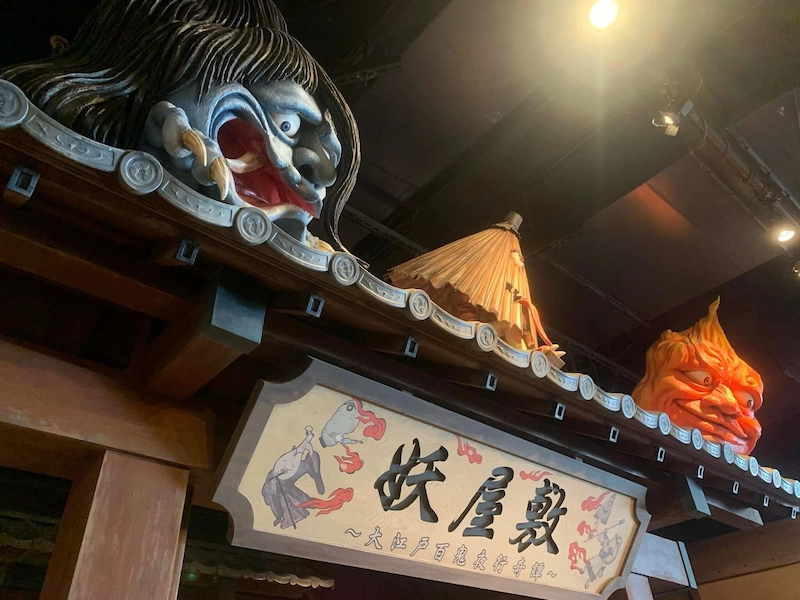 Traditional Japanese Yokai demon masks decorating the entrance of a haunted attraction in Joypolis.