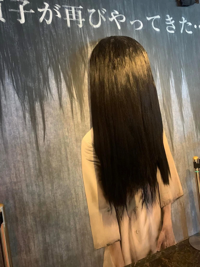 A prop of the long-haired Sadako character from The Ring horror attraction at Joypolis.
