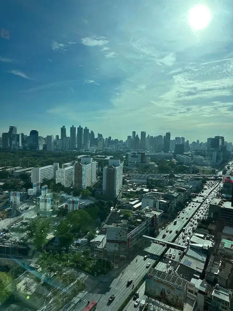 Daytime view over Lumpini Park and the Bangkok skyline from a room at Aetas Lumpini hotel