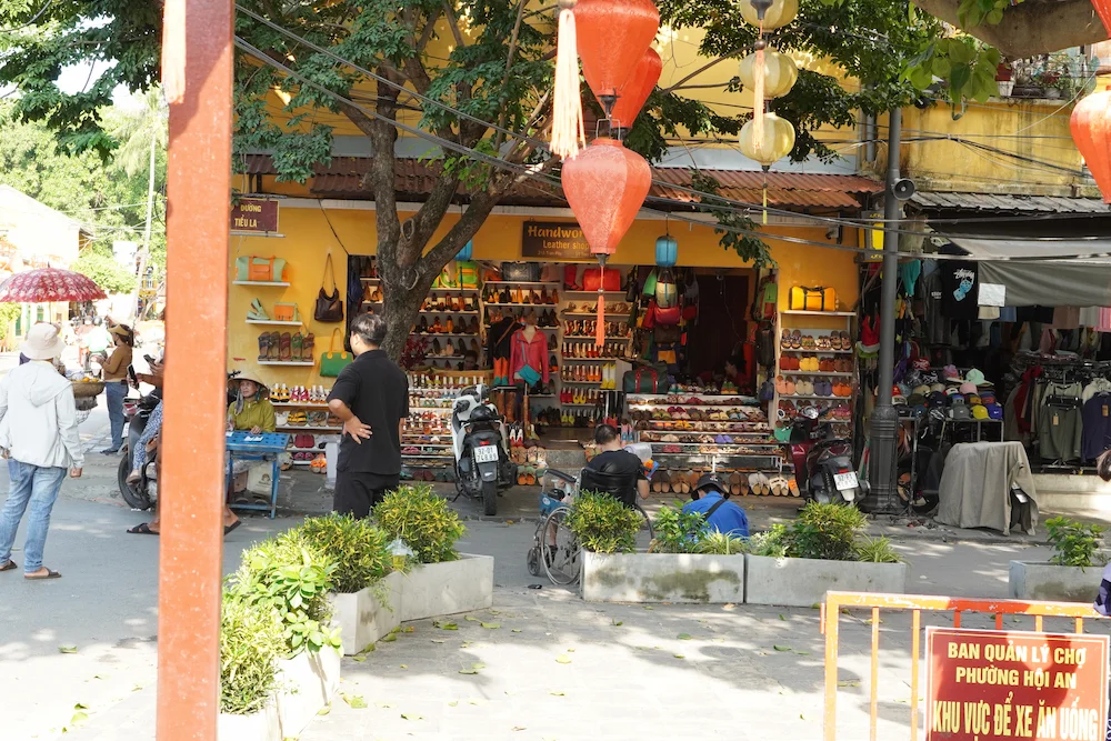 Shops in a yellow building decorated with lanterns in Hoi An Ancient Town, Vietnam