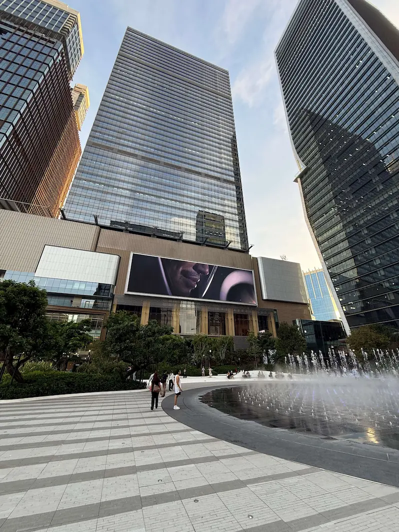 Modern office towers and fountain plaza at One Bangkok near Lumpini Park