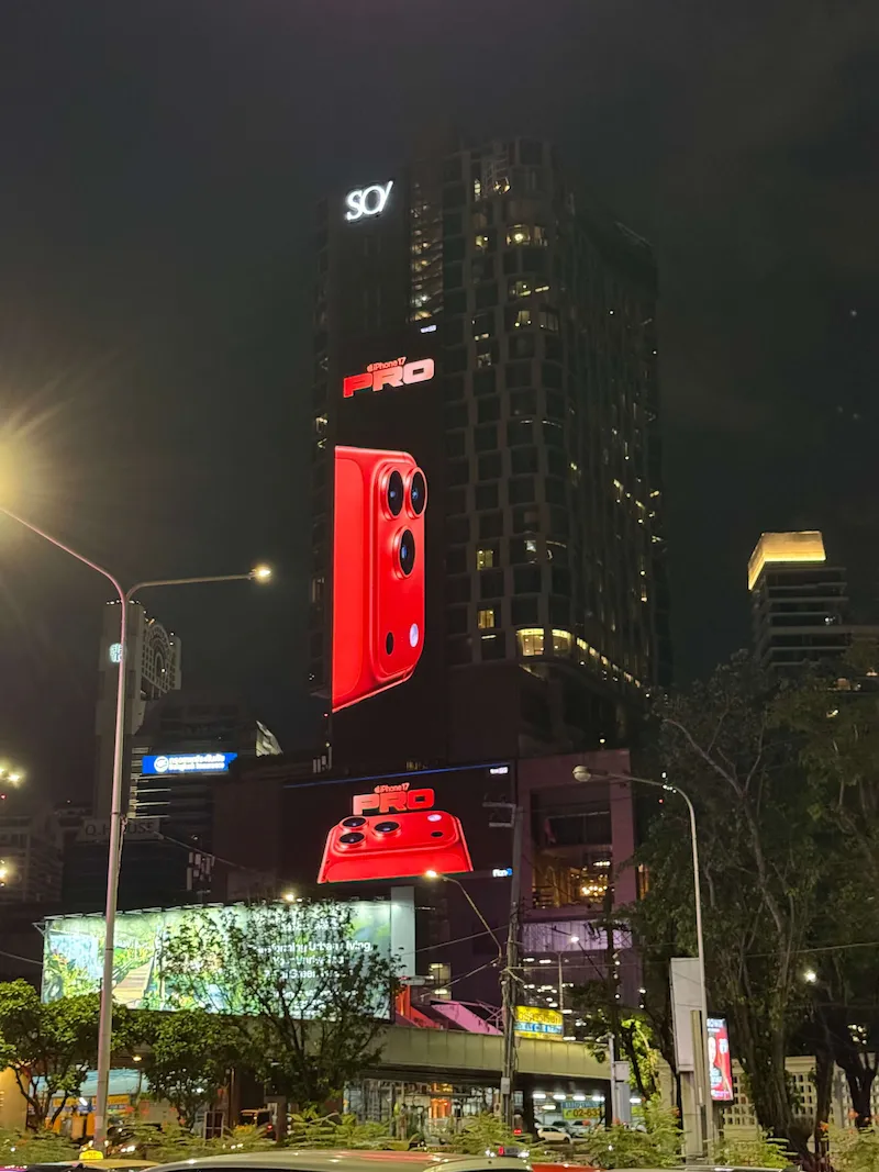 SO/ Bangkok hotel tower lit up at night on Rama IV Road, across from Lumpini Park