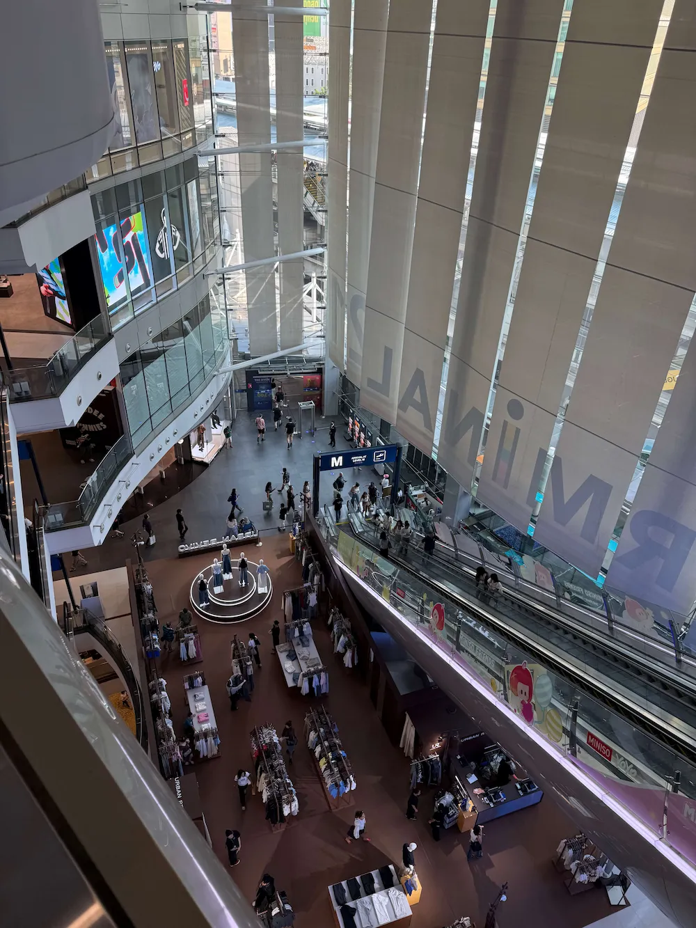 Multi-level atrium inside Terminal 21 shopping mall at Asok, Bangkok, seen from an upper floor