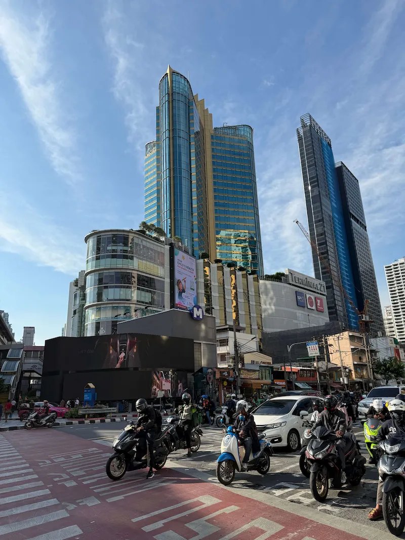 Busy Asok intersection with motorbikes in front of Terminal 21 shopping mall in Bangkok